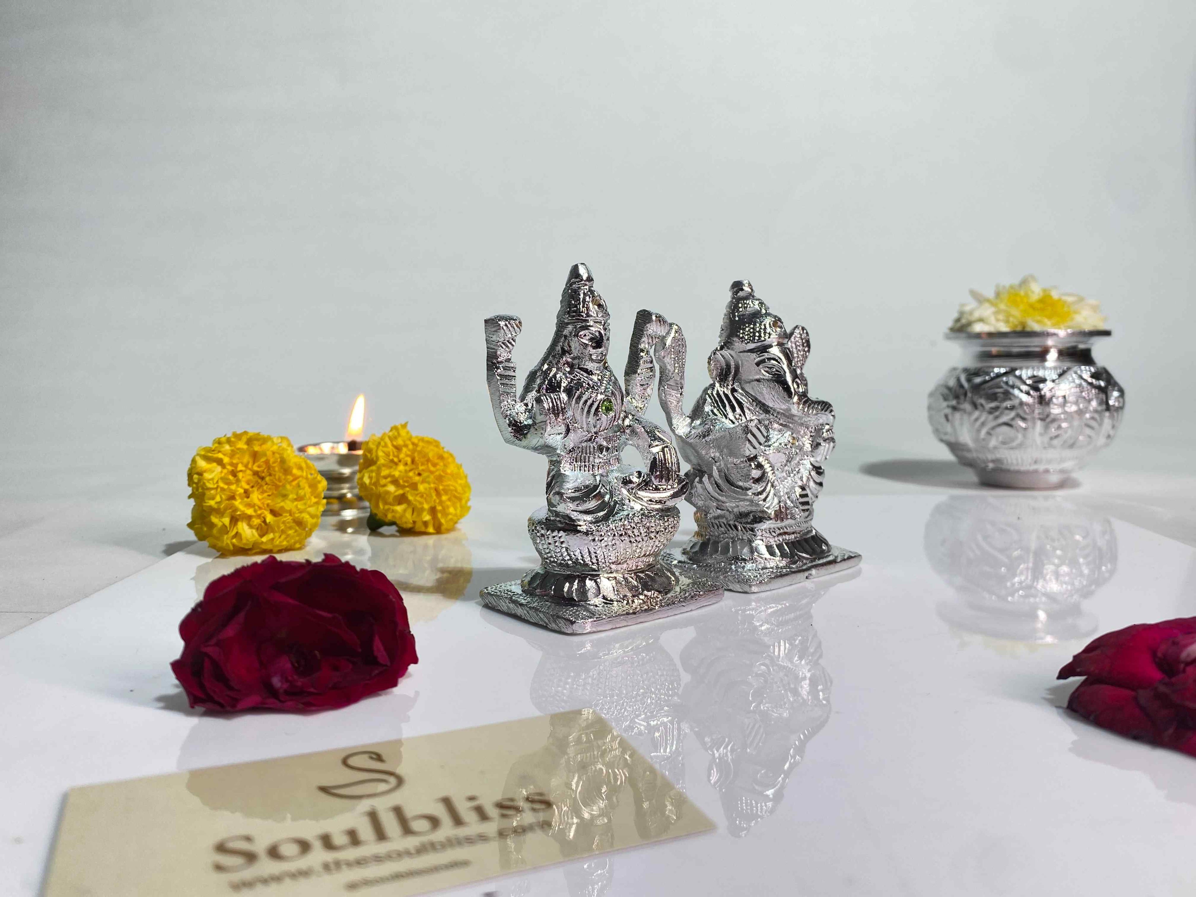 Silver Ganesha statues with flowers