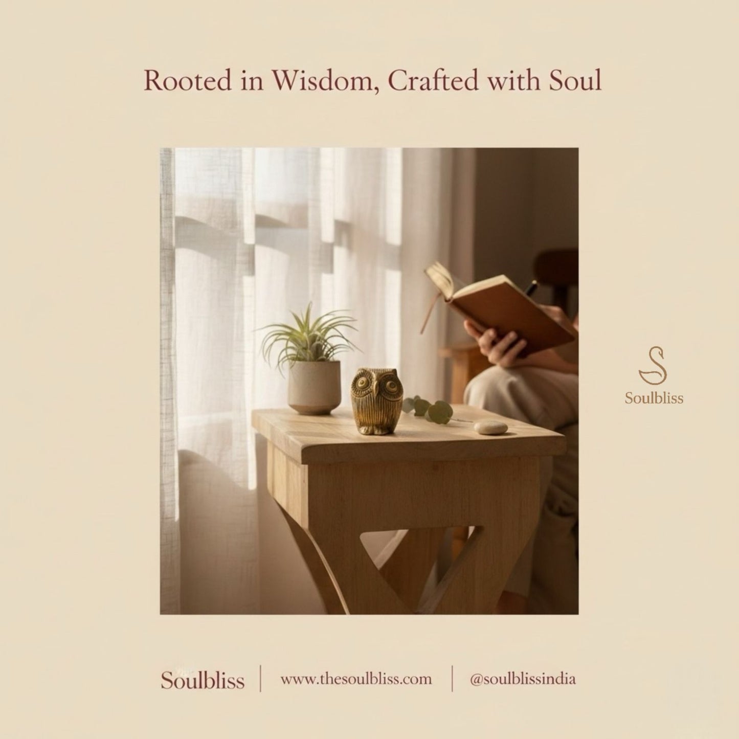Person reading a book in a cozy room with a wooden table, plant, and owl figurine.