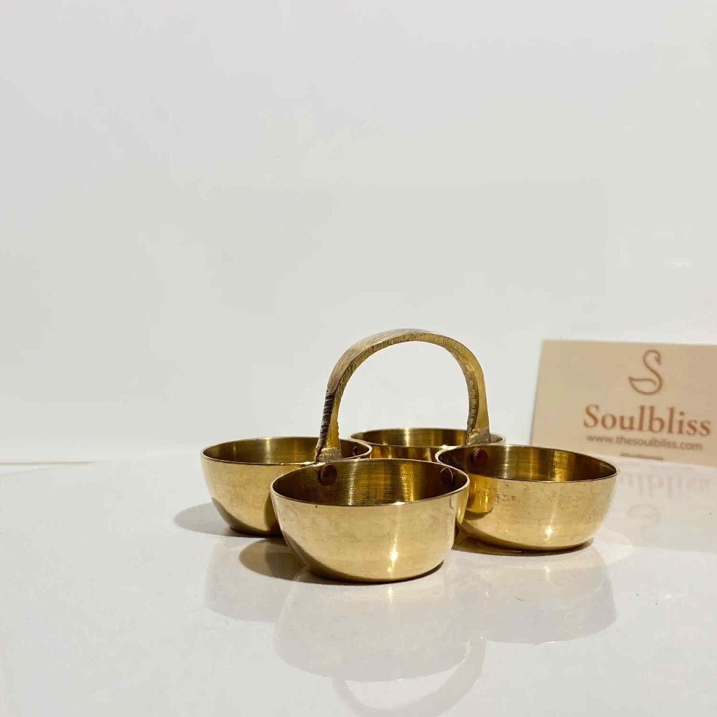 Set of gold bowls with a 'Soulbliss' card on a white background