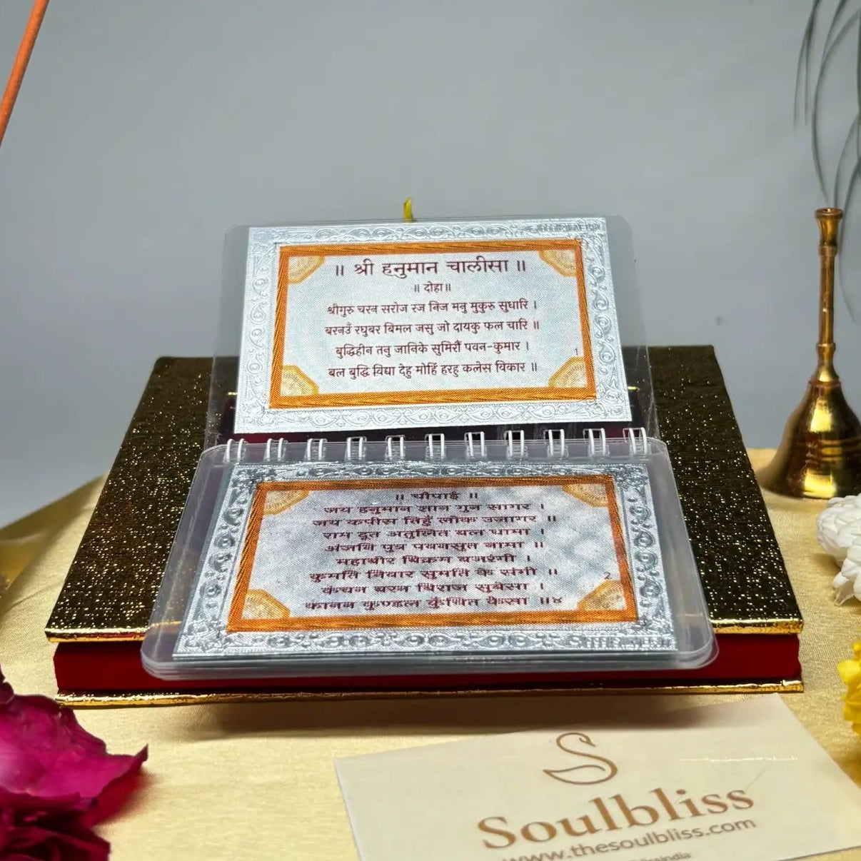 Incense sticks, flowers, and a book with text on a gray background