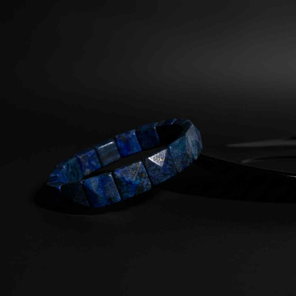 Blue beaded bracelet on a dark background