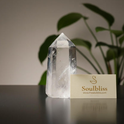 Clear crystal tower on a reflective surface with a 'Soulbliss' card in the background