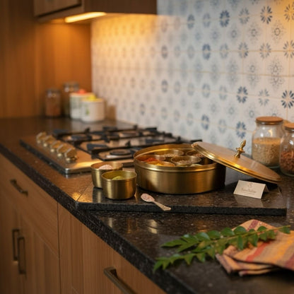 Kitchen counter with pots, pans, and ingredients on a dark countertop.