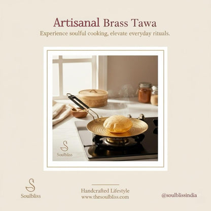 Artisanal brass tawa being used on a stove with a neutral background, featuring Soulbliss brand.