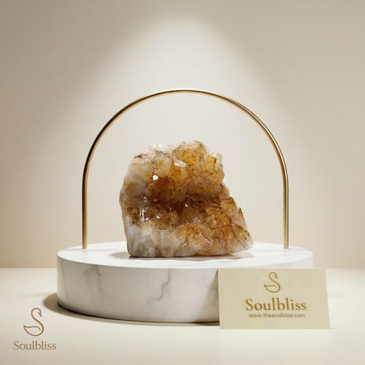 Crystal on a marble base with gold arch, branded 'Soulbliss' on a neutral background