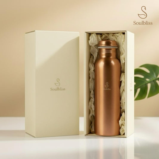 Copper bottle in a gift box with 'Soulbliss' branding on a neutral background