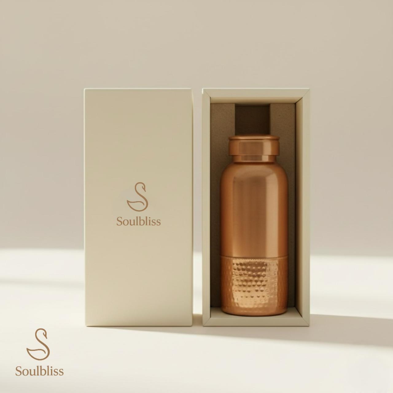 Copper water bottle in a 'Soulbliss' branded box on a light background