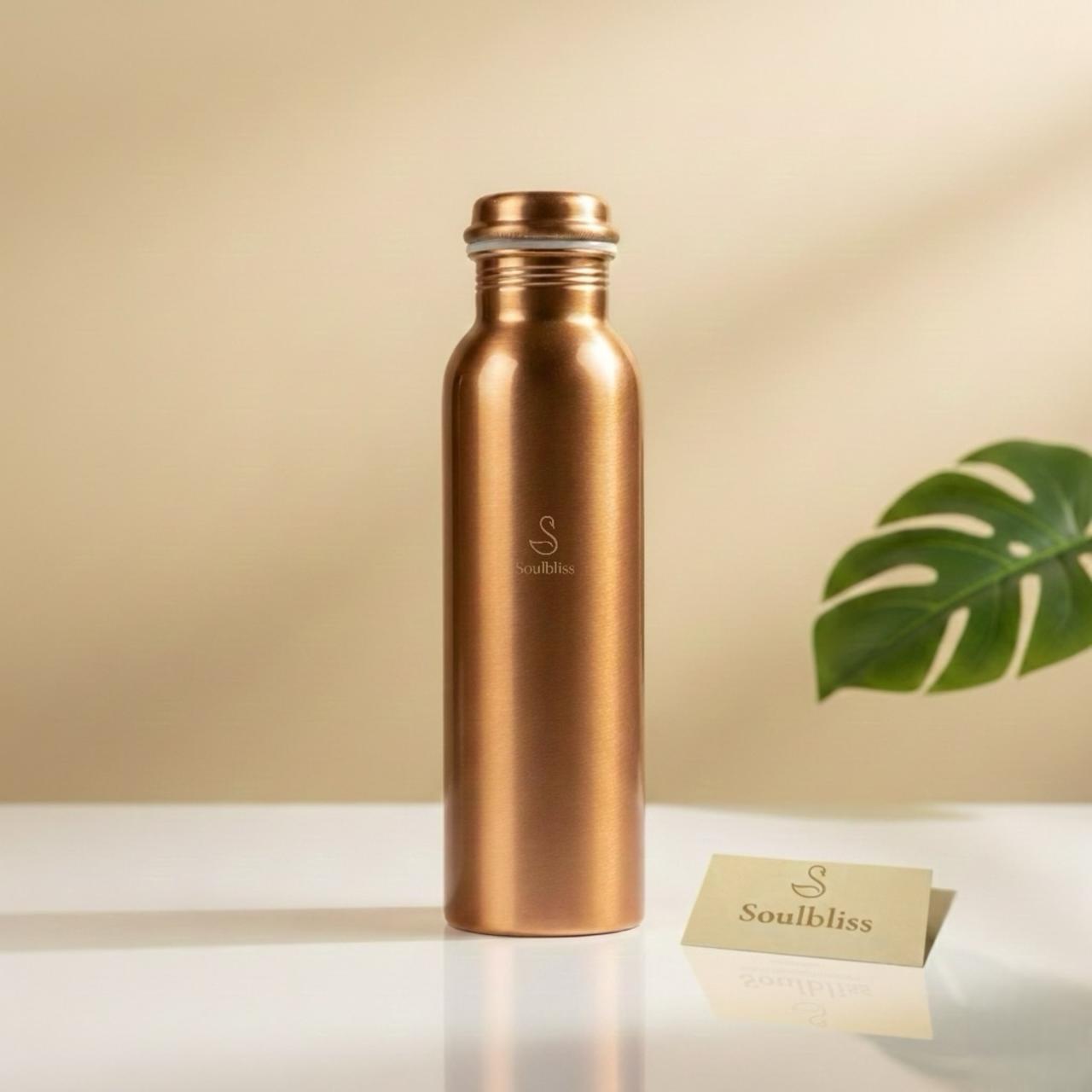 Copper-colored water bottle with 'Soulbliss' branding on a beige background