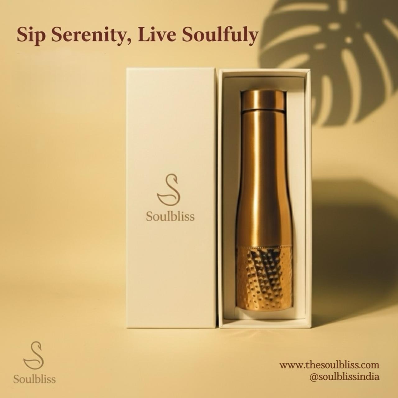 Gold bottle with packaging on a beige background, featuring 'Soulbliss' brand.